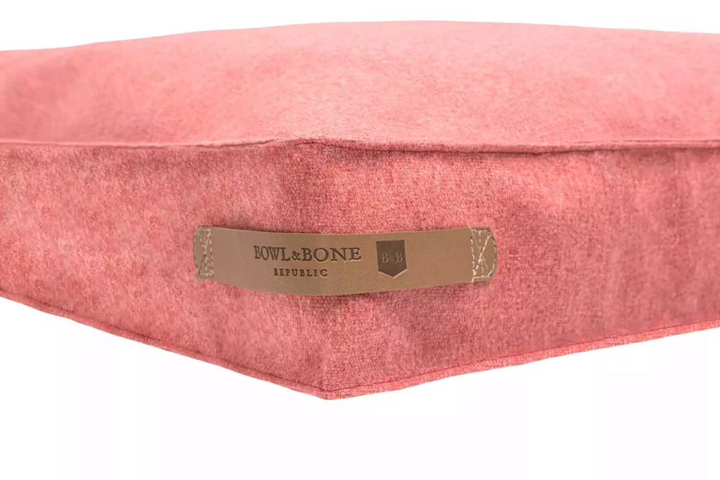 dog cushion coral close-up