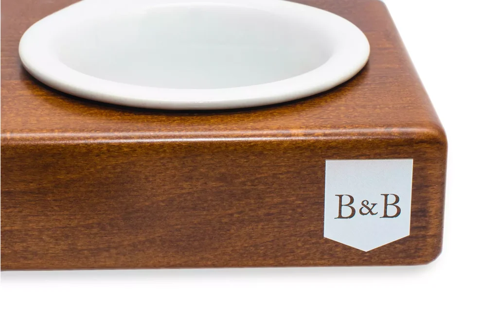 dog bowl ceramic light brown with wooden frame close-up